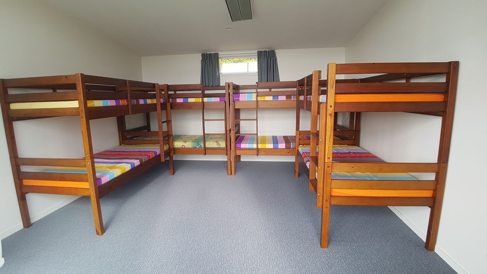 A cabin with wooden bunks sleeping eight