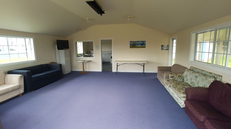 The multi-purpose room with sofas, tables and a TV